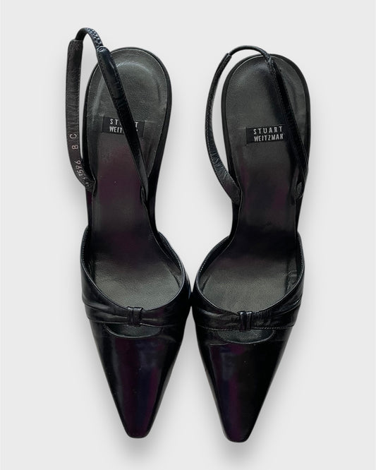 Black high-heeled shoes with 'Stuart Weitzman' branding on a white background