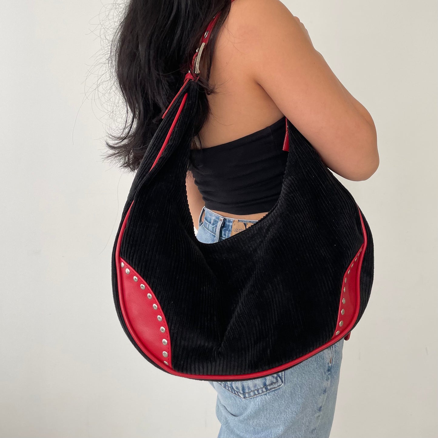 T...T Black Moon Shaped Corduroy Bag with Red Straps and Silver Grommets