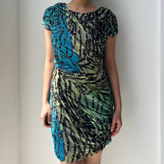 Multicolored patterned dress worn by a person against a plain background